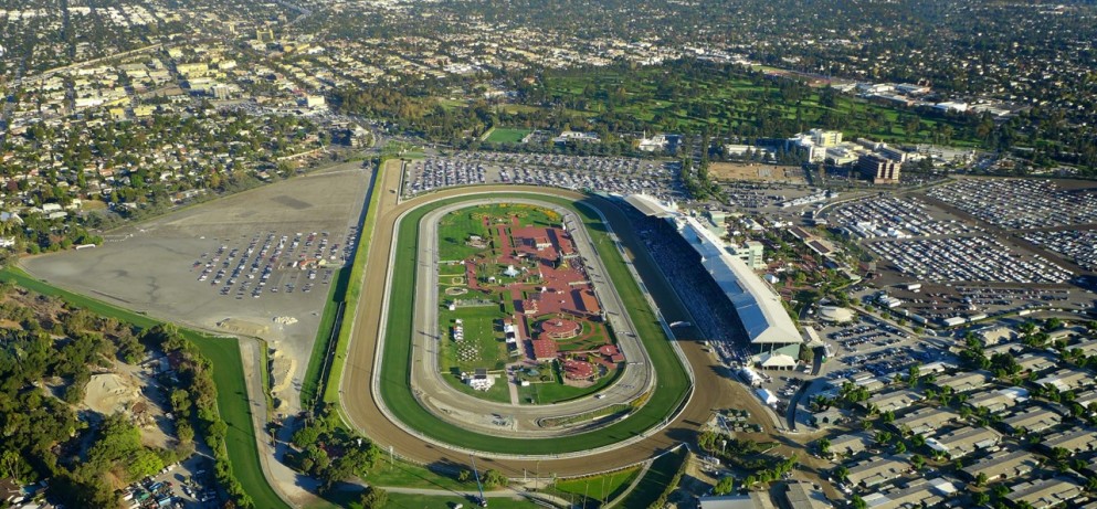 Aerial view of Santa Anita Park racecourse with surrounding parking and buildings.