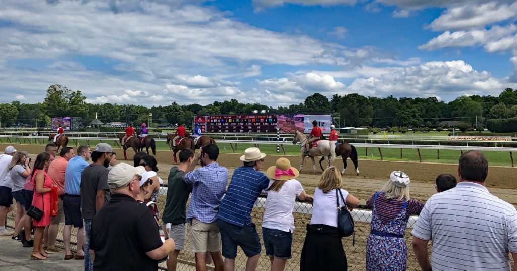 Exciting horse racing event featuring jockeys on horseback and enthusiastic spectators at the racetrack.