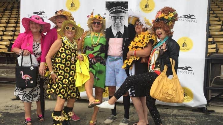 A vibrant group of women in colorful outfits posing together at an event, showcasing unique fashion styles and accessories.